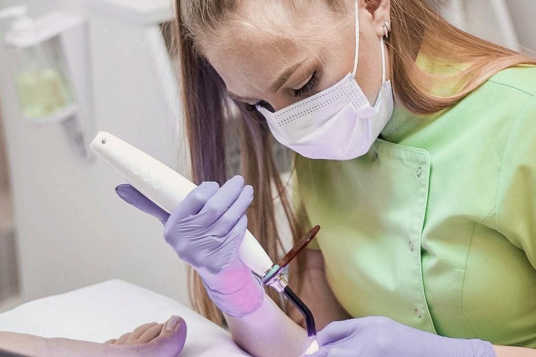 Hanna Lavrentsova opracowuje stopę frezarką, w rękawiczkach